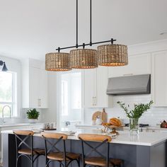 a kitchen with an island and stools in it