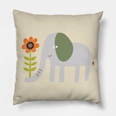 an elephant with a flower in its trunk on a beige pillow cover that has the image of an elephant and a sunflower