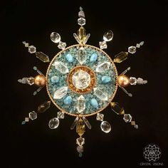 an elaborately designed brooch with many different colored stones and beads on it's center