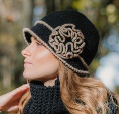 "1920s Winter Woman Hat with the flower in retro style. This is a beautiful warm cloche hat in black with a brim and a big flower. It is made from %40 wool and 60 acrylic soft yarn. It is ready to ship! You can use the hat as a beautiful accessory or just to keep yourself warm on cold winter days. Fits a head circumference of 22\"(57 cm).  How To Measure For A Hat? To measure your head circumference, take a sewing measuring tape or even a string, and wrap it around above the ears and across your Crochet Capelet Pattern, Crochet Capelet, Crochet Slouch Hat, African Hats, Crochet Cape, Woman Hat, Purple Hats, Bobble Hats, Crochet Woman