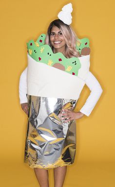 a woman wearing a costume made to look like an ice cream cone with green and yellow toppings