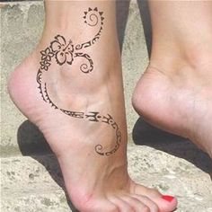 a woman's foot with a tattoo design on the top and bottom of it