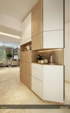 an empty living room with white cabinets and beige flooring in the middle of it