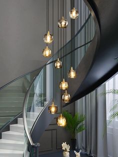 a spiral staircase with glass balls hanging from it