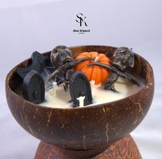 a wooden bowl filled with milk and halloween decorations