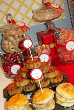 a table topped with lots of pastries and desserts on top of trays