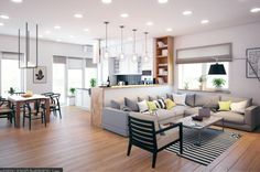 a living room filled with furniture next to a kitchen and dining room table on top of a hard wood floor