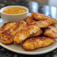 fried chicken sticks with dipping sauce on a plate