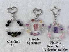 four different types of beaded charms on a white sheet with the names of them