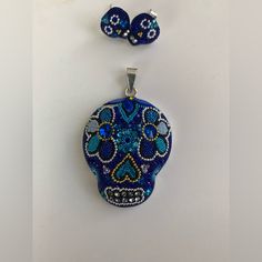 This Stunning One Of A Kind Piece Features A Meticulously Designed Sugar Skull Pendant, Adorned With Vibrant Blue Austrian Crystals And Beads. Crafted With Utmost Care And Precision, This Necklace Perfectly Blends Traditional Elegance With Contemporary Style. Made From High-Quality Silver 925, It Not Only Showcases Intricate Artistry But Also Ensures Lasting Durability. A Captivating Tribute To The Day Of The Dead Tradition, This Pendant Is A Unique Accessory That Resonates With Both Cultural Si Handmade Silver Skull Jewelry, Handmade Sterling Silver Skull Jewelry, Day Of The Dead Skull Jewelry Gift, Sugar Skull Necklace, Sugar Skull Earrings, The Day Of The Dead, Skull Necklace, Skull Pendant, Skull Earrings