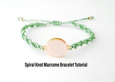 a green string bracelet with a gold disc on the end and a white bead around it