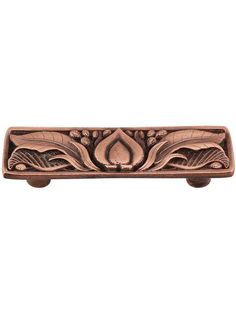 a decorative door handle with flowers and leaves on the front, in antique copper finish