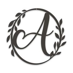 the monogramed letter is surrounded by an olive branch and leaves, making it appear to be made out of paper