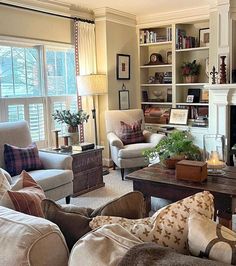 a living room filled with furniture and a fire place in the middle of a room