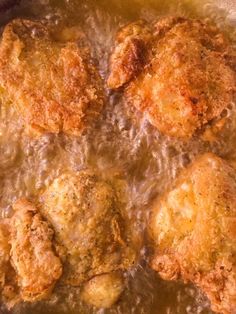 some fried food is being cooked in a frying pan