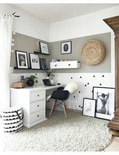 a white desk and chair in a room with pictures on the wall above it, along with black and white decor