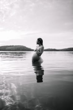 a pregnant woman is sitting in the water