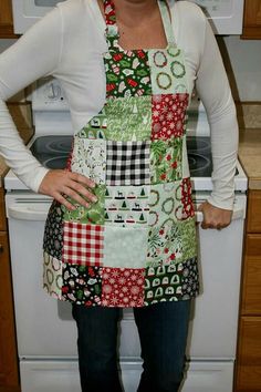 a woman standing in front of an oven with her hands on her hips