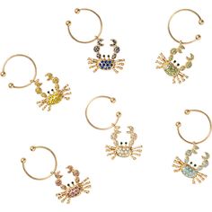 six pairs of gold tone hoop earrings with colorful crystal crab charms on each earring