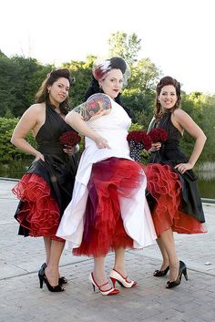 three women in dresses posing for the camera