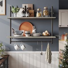 a shelf with dishes and utensils on it next to a potted christmas tree