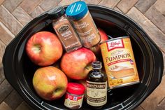 an image of apples and spices in a slow cooker