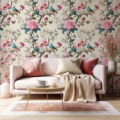 a living room with floral wallpaper and a white couch in front of a coffee table