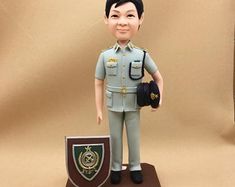 a figurine of a police officer holding a badge