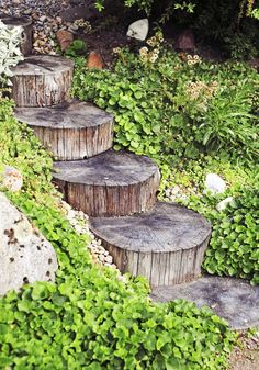 several wooden steps made out of logs in the grass