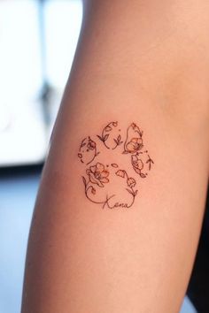 a woman's arm with a small tattoo design on the back of her left arm