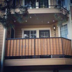 an apartment building with balconies and lights on the balcony