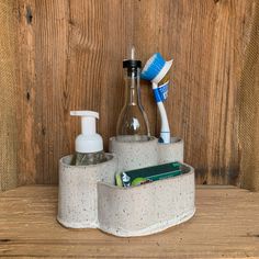 two toothbrushes, soap and lotion sitting in a holder