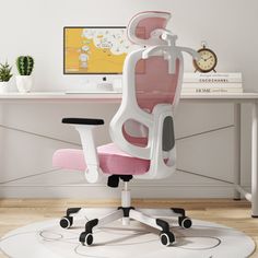 a pink and white office chair sitting in front of a computer desk