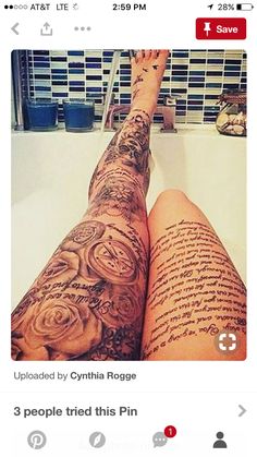 a person with tattoos on their legs sitting in a bathtub next to a sink