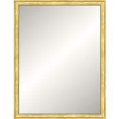 a gold framed mirror on a white wall