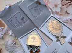 an open wedding card and its contents on a table