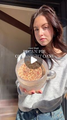 a woman holding a bowl of food in her hands