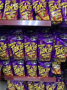 many bags of takie are stacked on the shelf in a grocery store for sale