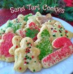 christmas cookies on a plate with the words sand tart cookies