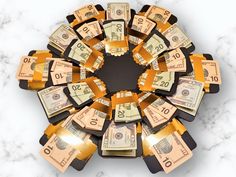 a circular arrangement of twenty dollar bills on a marble counter top with the number ten