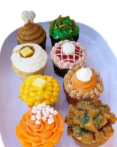 a white plate topped with different types of cupcakes