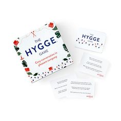 the hygge game is shown with four cards and two envelopes on top