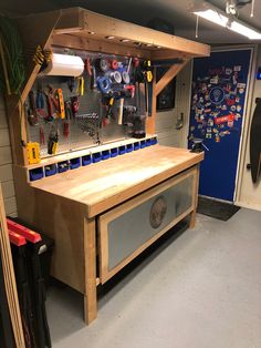 a workbench with tools hanging on the wall