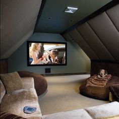 a home theater in the corner of a room with two couches and a television