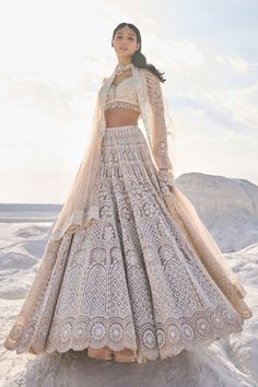 This nude net lehenga set features ivory thread, sequin, and pearl embroidery. The plunging neckline shows pearls along the v neck. The sleeves of the blouse have pearl tassels at the hem. The dupatta has a scalloped border on all four sides.From Seema Gujral's Elements collection. DELIVERY TIMEPlease allow 6-8 weeks for your outfit to arrive. FABRIC DETAILSNet Professional cleaning only. Ivory Lehenga Bridal, Champagne Beach, Ivory Lehenga, Pearl Tassels, Indian Outfits Lehenga, Pearl Embroidery, Scalloped Border, Net Lehenga, Pearl Details