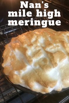 a pie sitting in an oven with the words nan's mile high meringue