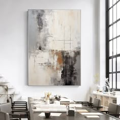 an abstract painting hangs on the wall above a dining room table with chairs and place settings