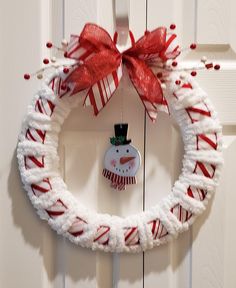 Adorn you wall or your inside door with this cute yarn snowman wreath. Made with white yarn and red strip ribbon. Decorated with a cute whimsical snowman. Adorn with a beautiful red and white stripe bow and red and white berries. Made on a 14 inch wire round frame. Very lightweight. Handmade by me with care. Ready for shipping.  Thank you for stopping by. "Favorite My Shop" to view all my new listings. Feel free to browse the rest of my shop: http://www.etsy.com/shop/BettyAnncreations.   Any questions please feel free to reach out to me @momdearest1953@yahoo.com Yarn Snowman, Spray Painted Wine Bottles, Whimsical Snowman, Wreath Snowman, Dollar Tree Christmas Decor, White Berries