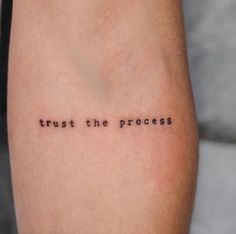 a tattoo saying trust the process on someone's leg