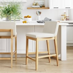 two stools sitting in front of a kitchen counter